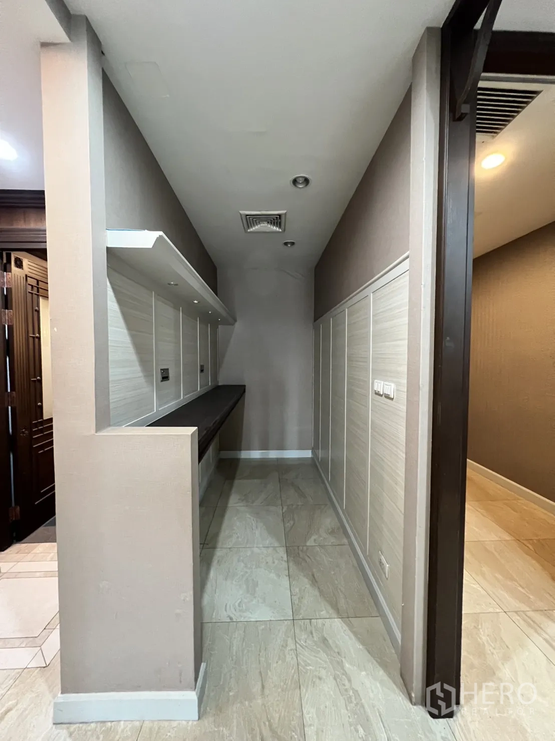 Office Space for rent in Watthana, Bangkok - Narrow utility corridor with built-in shelves and tiled floor.