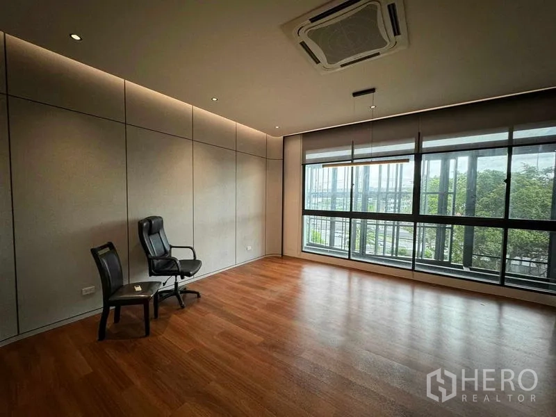 Home Office for rent or sale in Bang Phli, Samut Prakan - Corner office with floor‑to‑ceiling windows, wood flooring and cassette air‑conditioning.
