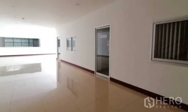 Warehouse for rent in Bang Bo, Samut Prakan - Administration corridor with glass windows and office doors.