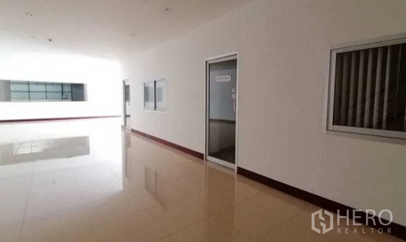 Warehouse for rent in Bang Bo, Samut Prakan - Administration corridor with glass windows and office doors.