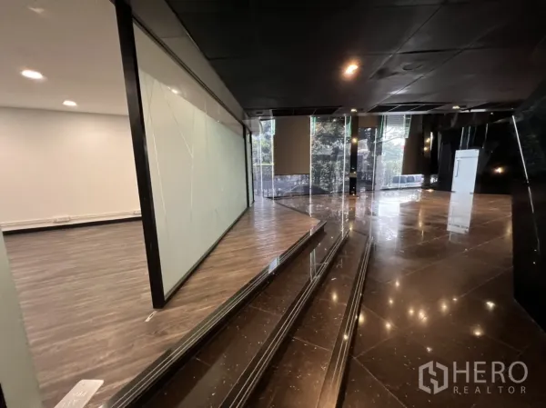 Retail Space for rent in Sathon, Bangkok - Lobby area with glossy marble floor, ramp and glass partitions in dark contemporary tones.