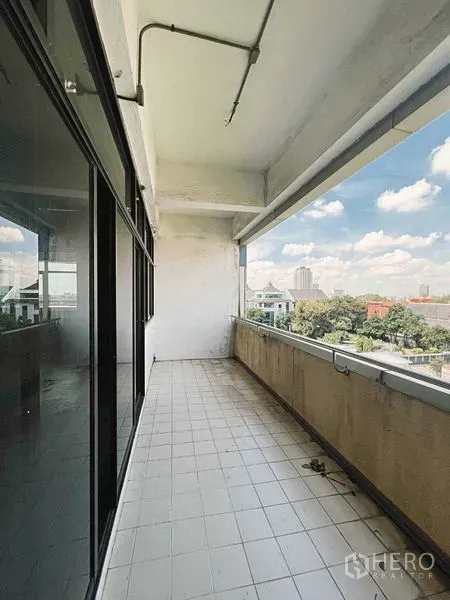 Retail Space for rent in Yan Nawa, Bangkok - Covered balcony with tiled floor and city view beside glass facade on an upper floor.