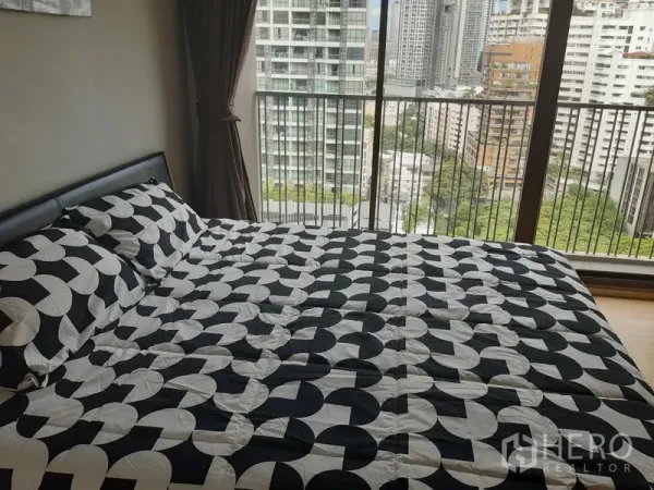 公寓 出租在Bangkok - 大床紧邻推拉落地门，高楼层城市景观一览无余。