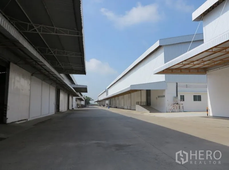 คลังสินค้า ให้เช่าในLopburi - ถนนลานคอนกรีตกว้างสำหรับรถบรรทุก ระหว่างแถวโกดังพร้อมกันสาด