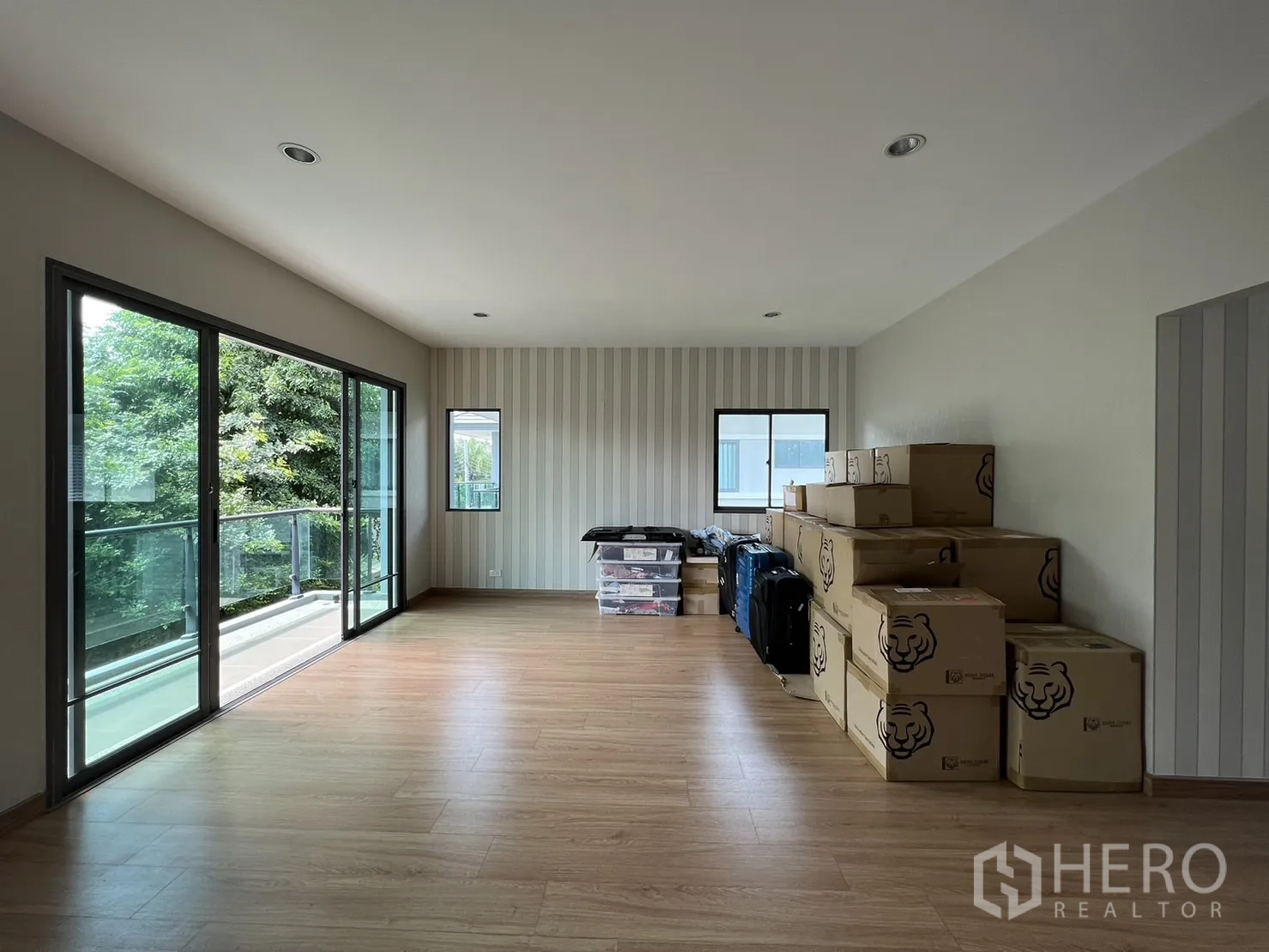 Detached House for sale in Suan Luang, Bangkok - Upstairs family room with wood floors and sliding doors to balcony.