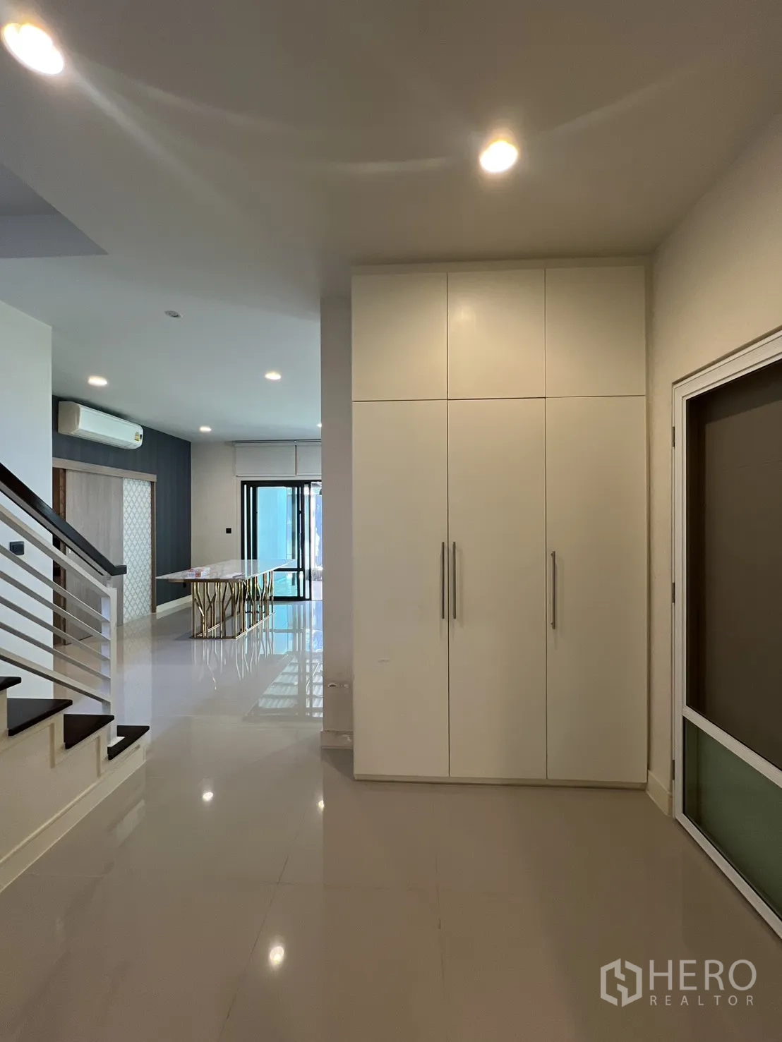 Detached House for sale in Bang Kapi, Bangkok - Hallway with built-in white storage cabinet near the stairs.