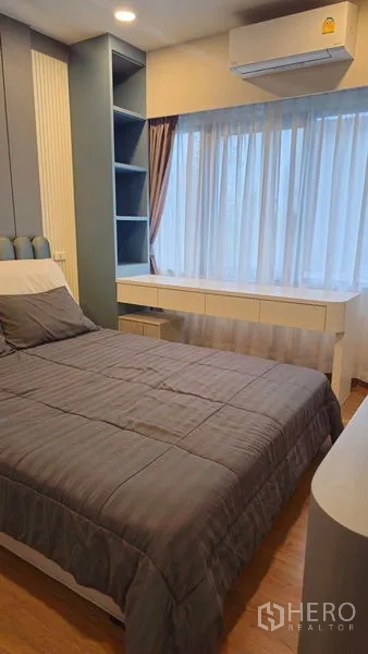 Detached House for sale in Sai Mai, Bangkok - Guest bedroom with built-in shelving, desk and air conditioning in Sai Mai, Bangkok.