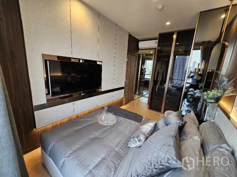 Condominium for rent - Master bedroom opposite view showing wall-mounted TV and wardrobes.