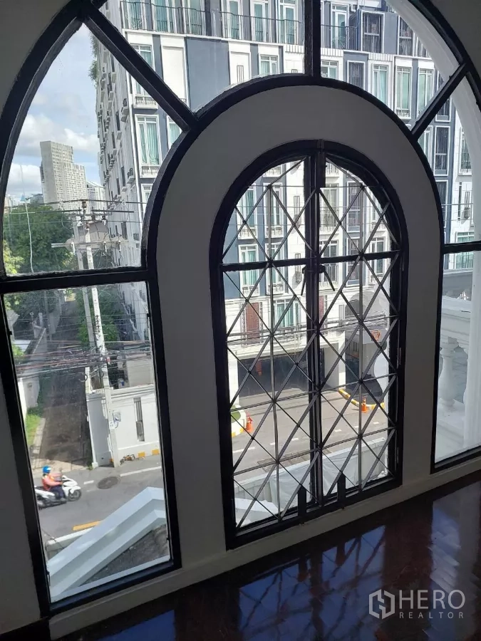 Home Office for rent in Yan Nawa, Bangkok - Large arched windows offering street and condo views.