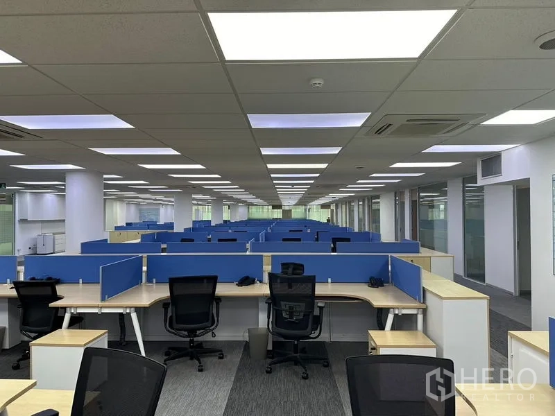 Office Space for rent - Executive office with glass wall, vertical blinds, wood accent wall and meeting table.