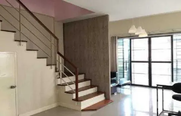 Home Office for rent in Lat Phrao, Bangkok - Open-plan living space with modern staircase, large windows and pendant lights.