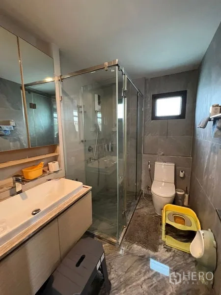 Detached House for sale in Bang Kapi, Bangkok - Modern bathroom with glass shower enclosure, vanity and natural light.