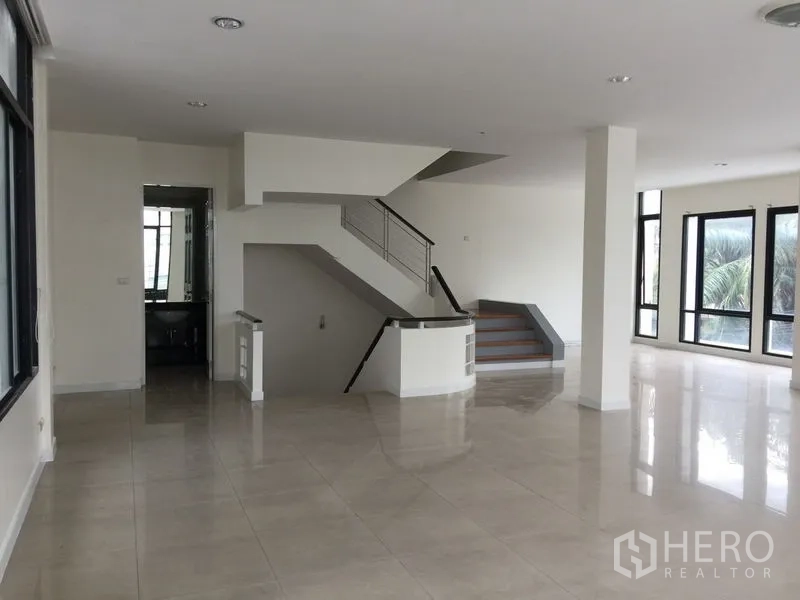 Office Space for rent in Bang Kho Laem, Bangkok - Open workspace with central staircase and tall windows providing natural light.