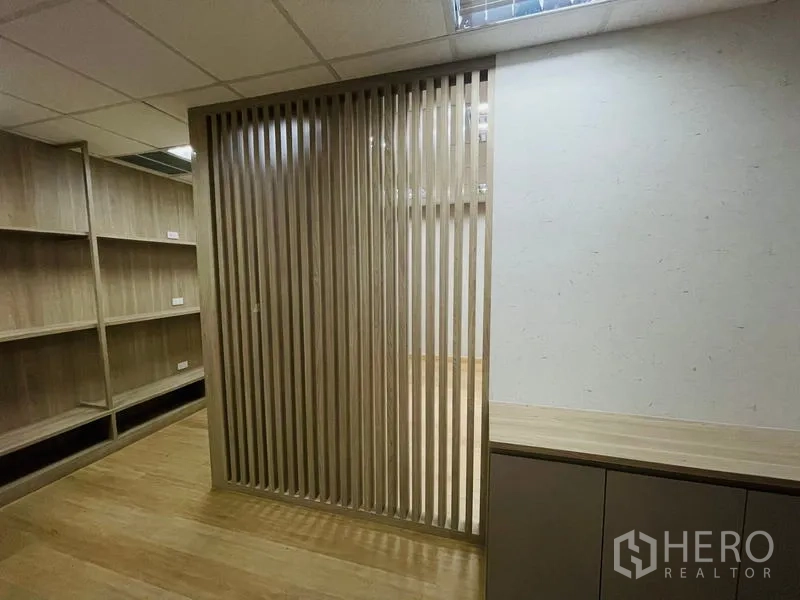Office Space for rent - Wooden slat screen dividing storage area and workspace.