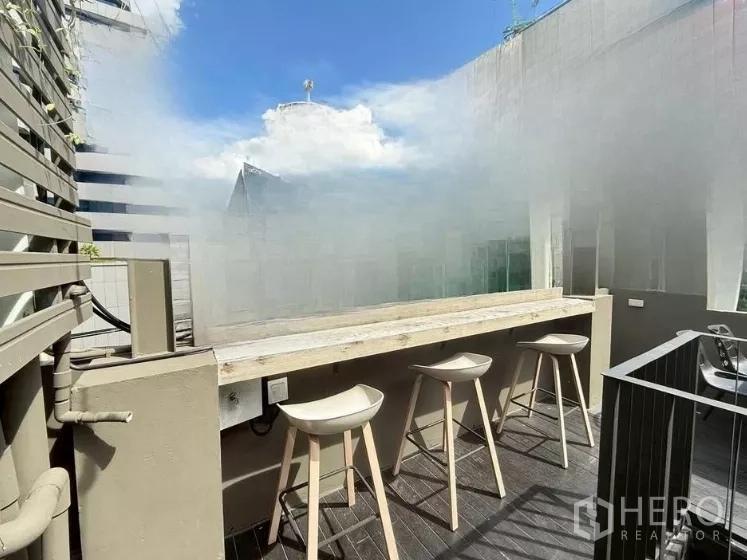 Retail Space for rent in Watthana, Bangkok - Outdoor counter with three bar stools on a rooftop deck overlooking nearby buildings.