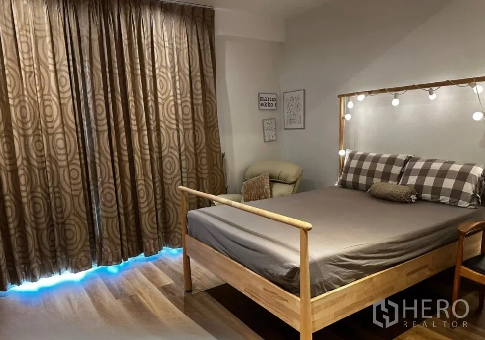 联排别墅 for rent in Sathon, Bangkok - 卧室配双人床、氛围灯、躺椅与遮光窗帘。