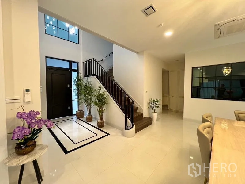 Detached House for rent or sale in Saphan Sung, Bangkok - Elegant foyer with stairway, indoor plants and tiled flooring.