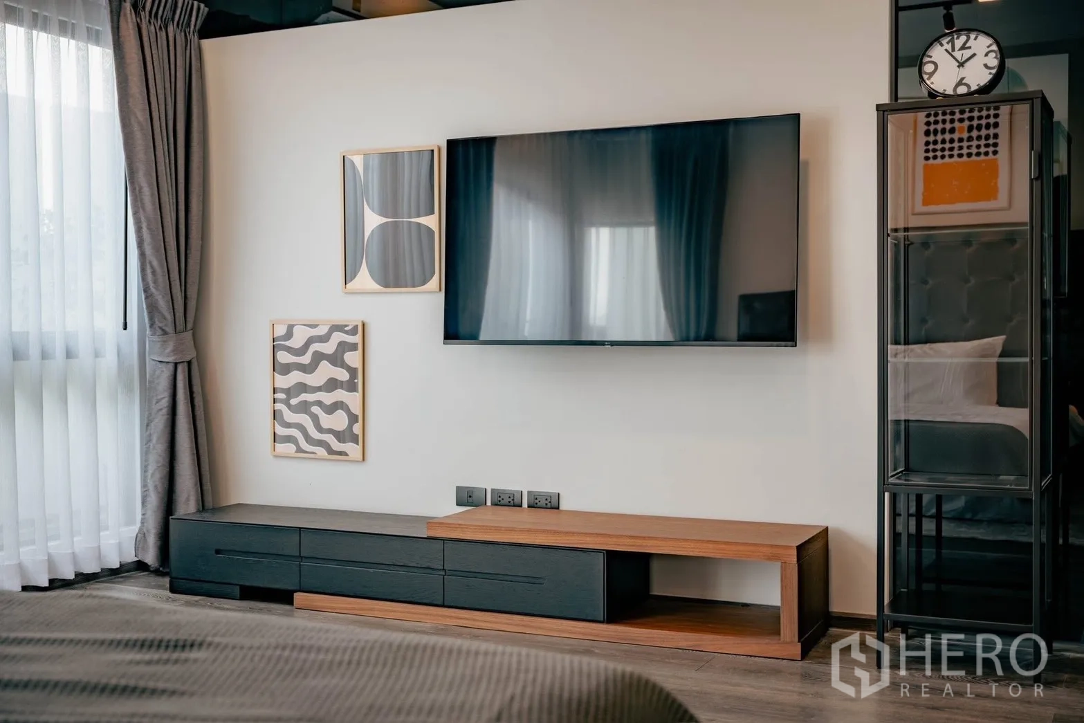 Detached House for rent or sale in Bang Phli, Samut Prakan - Master suite media wall with large TV, low console and framed art.