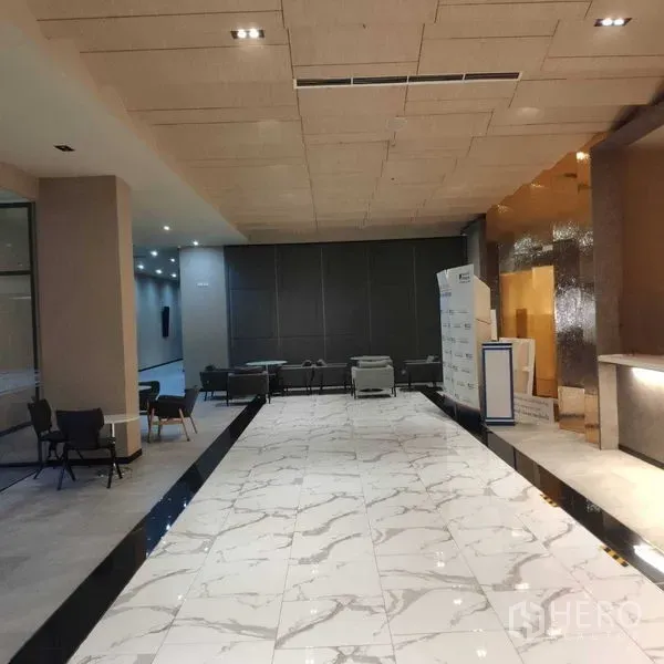 Office Space for rent - Modern lobby with marble flooring, reception counter and casual seating.
