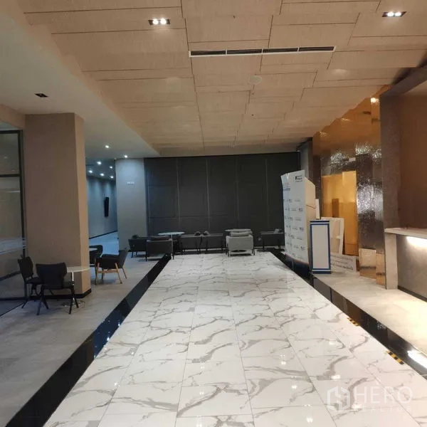 Office Space for rent - Modern lobby with marble flooring, reception counter and casual seating.