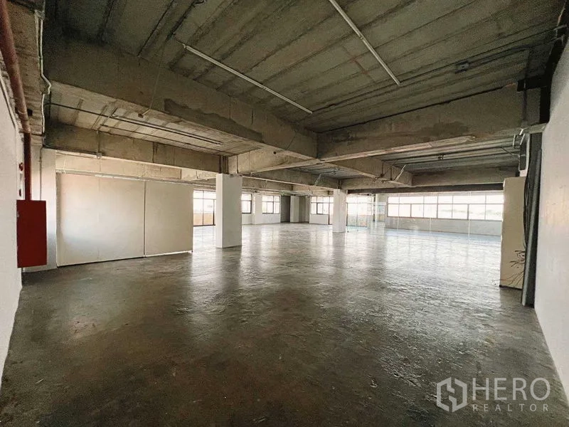 Retail Space for rent in Yan Nawa, Bangkok - Wide retail floor with polished concrete, multiple columns, and wraparound windows.