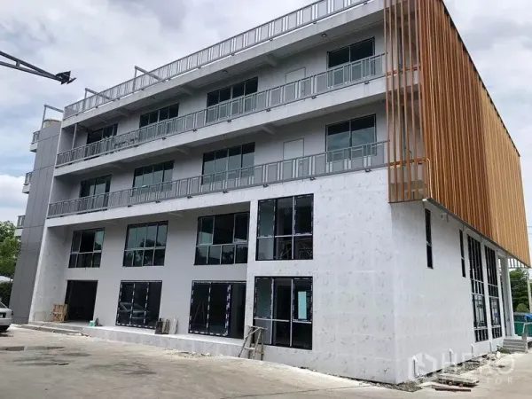 Office Space for rent in Lat Krabang, Bangkok - Modern four-storey office building with balconies and vertical wooden fins in Lat Krabang, Bangkok.