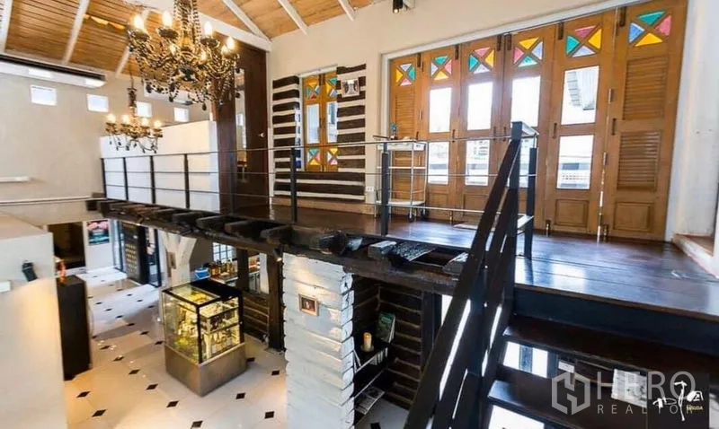 Retail Space for rent in Khlong Toei, Bangkok - Mezzanine level with chandeliers, wood flooring and folding doors with colored glass.