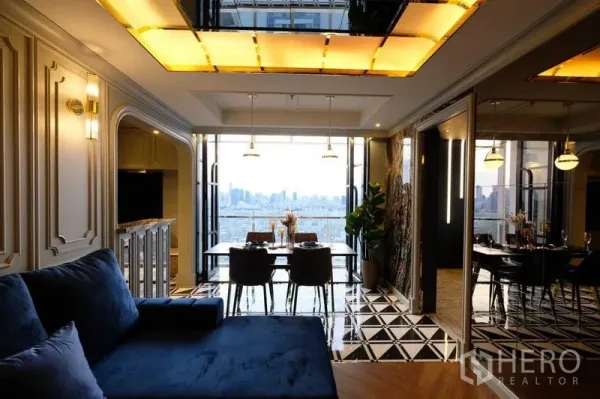Condominium for sale - Wide shot of living and dining space opening to a skyline balcony in a Din Daeng condo.