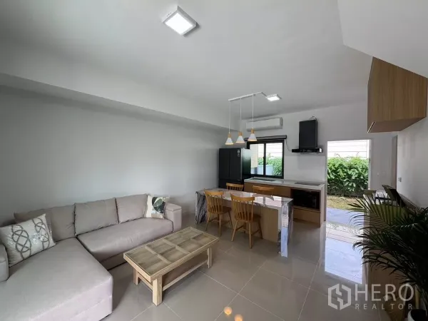 Townhouse for rent in Bang Phli, Samut Prakan - Bright living area with pendant lights and sliding door leading to the backyard.