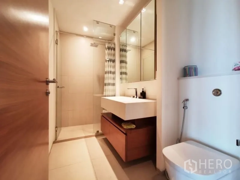公寓 出租或出售在Khlong San, Bangkok - 现代卫浴，设洗手台、镜柜与玻璃淋浴间。