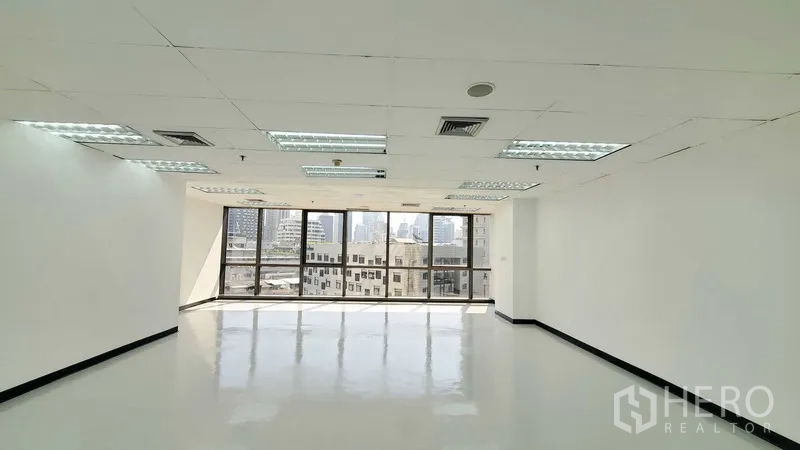 办公空间 出租在Watthana, Bangkok - 明亮的开放式办公室，大窗户采光与城市景观，亮面地坪与吊顶灯光，位于曼谷瓦他那区。