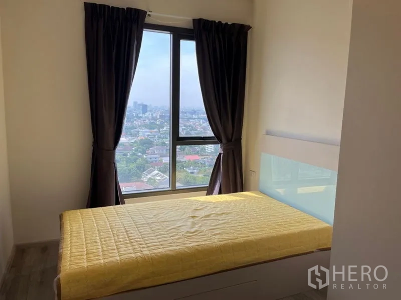 Condominium for sale in Phaya Thai, Bangkok - Second bedroom with large window, blackout curtains and city outlook.