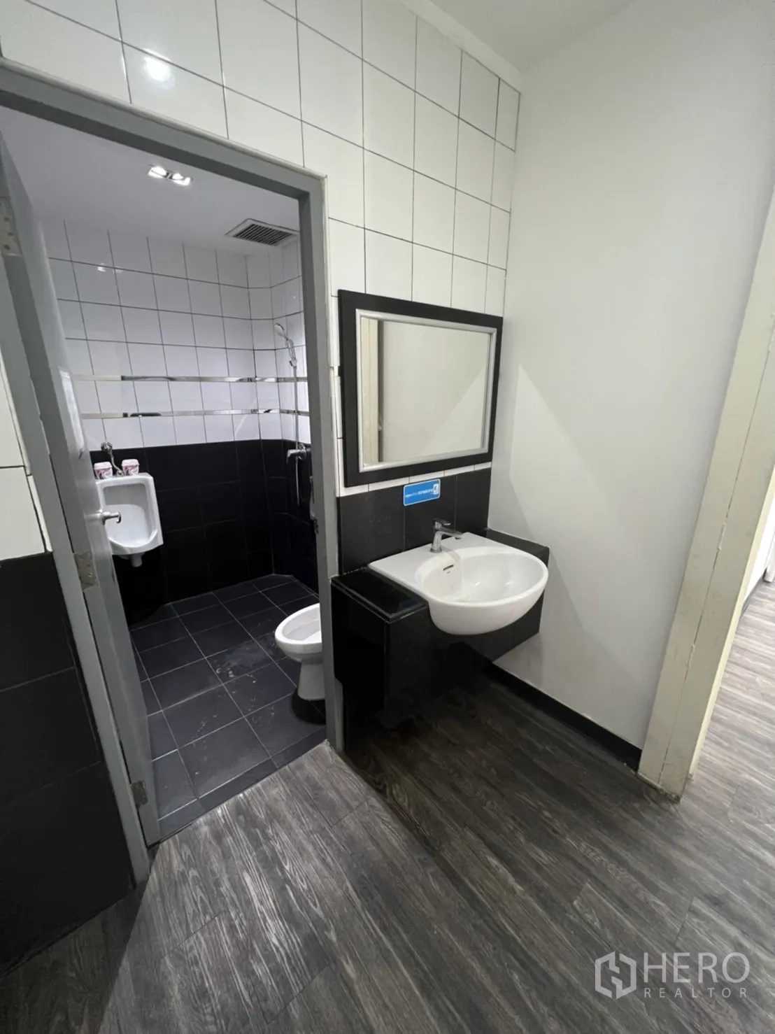 Retail Space for rent in Sathon, Bangkok - Restroom entrance with sink leading to the toilet and urinal area.