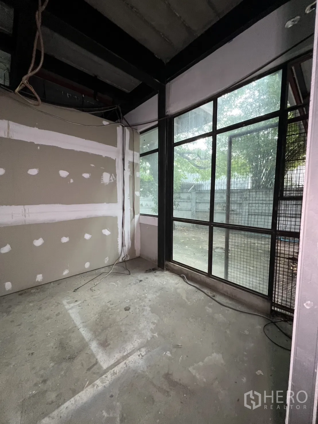 Retail Space for rent in Watthana, Bangkok - Stairwell with wooden steps and a tall window bringing natural light.