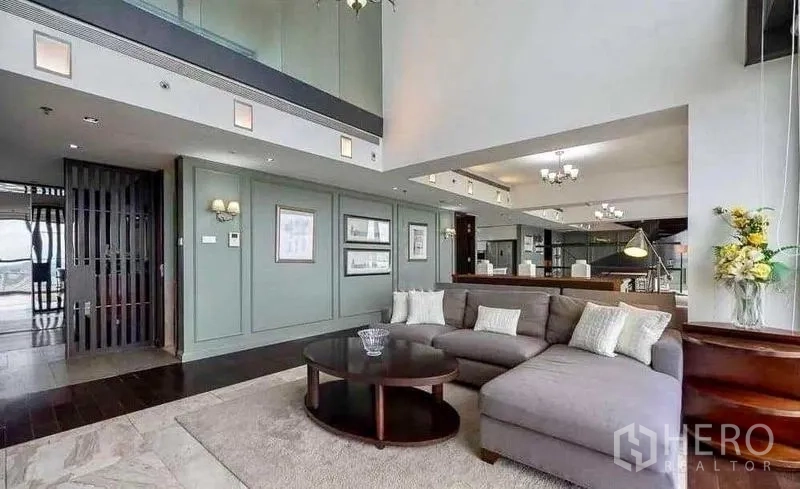 Condominium for rent - Long living hall with sectional sofa, rugs and skyline windows.