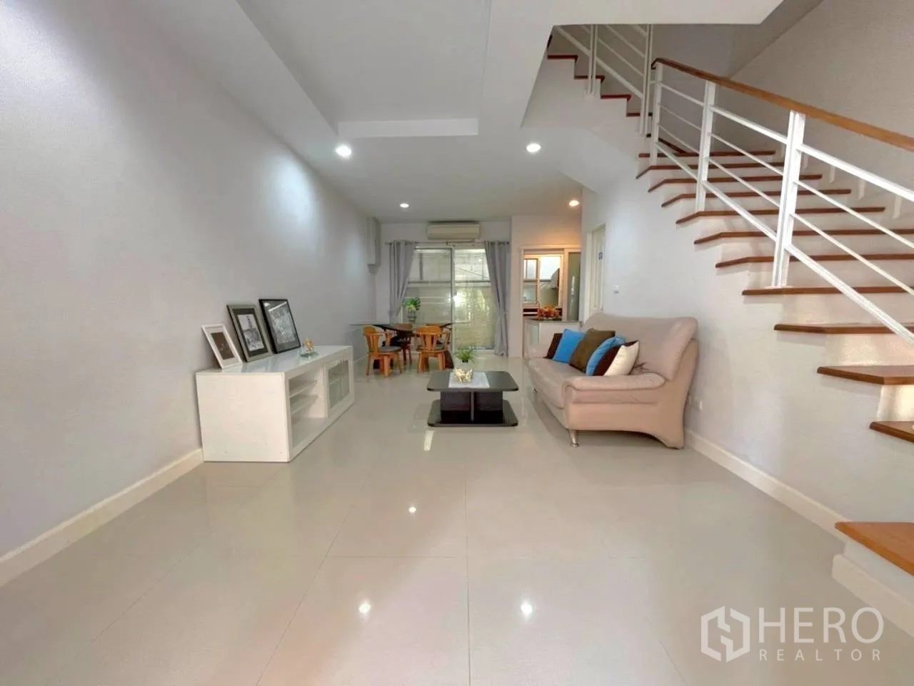 ทาวน์เฮาส์ for rent in Bang Kho Laem, Bangkok - ห้องนั่งเล่นแบบโอเพ่นสเปซพร้อมโซฟา ชั้นวางทีวี และบันไดขึ้นชั้นบน.