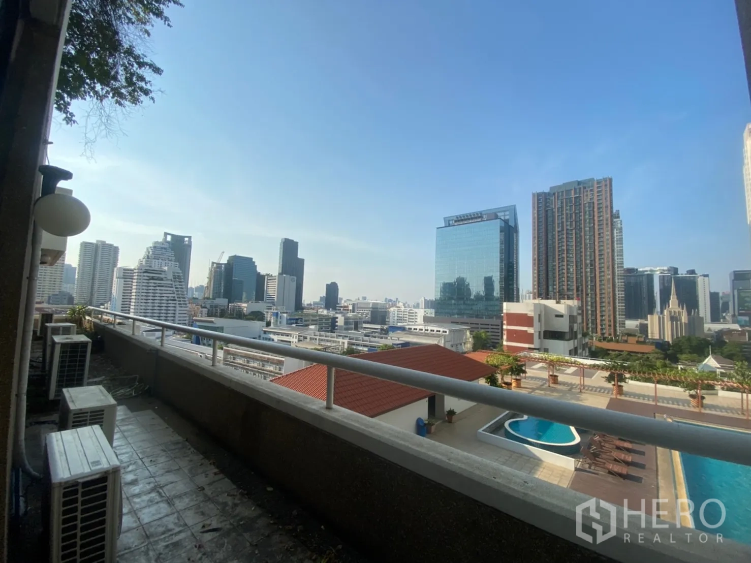 Condominium for rent or sale in Watthana, Bangkok - Long balcony with open Bangkok skyline and a view of the swimming pool and sundeck below.