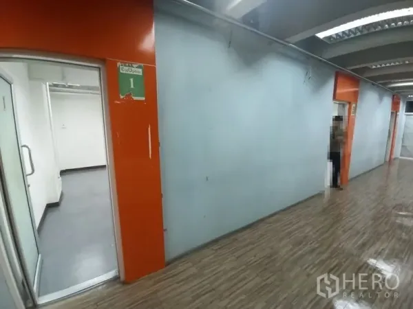 Office Space for rent in Ratchathewi, Bangkok - Interior corridor with orange accents, blue walls and entrances to multiple office units.