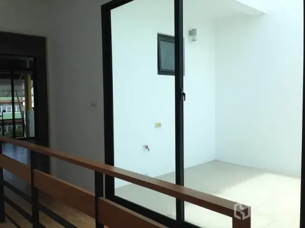 Townhouse for rent in Yan Nawa, Bangkok - Covered utility terrace with sliding glass door and wall tap.