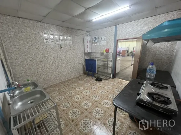 Retail Space for rent in Watthana, Bangkok - Rear service room with tiled walls, sink, gas stove and ventilation hood for light food preparation.