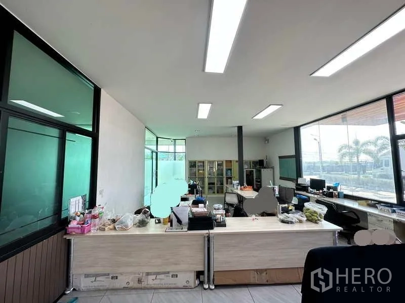 Warehouse for rent in Lam Luk Ka, Pathum Thani - Bright office workspace with desks, windows and built-in storage.
