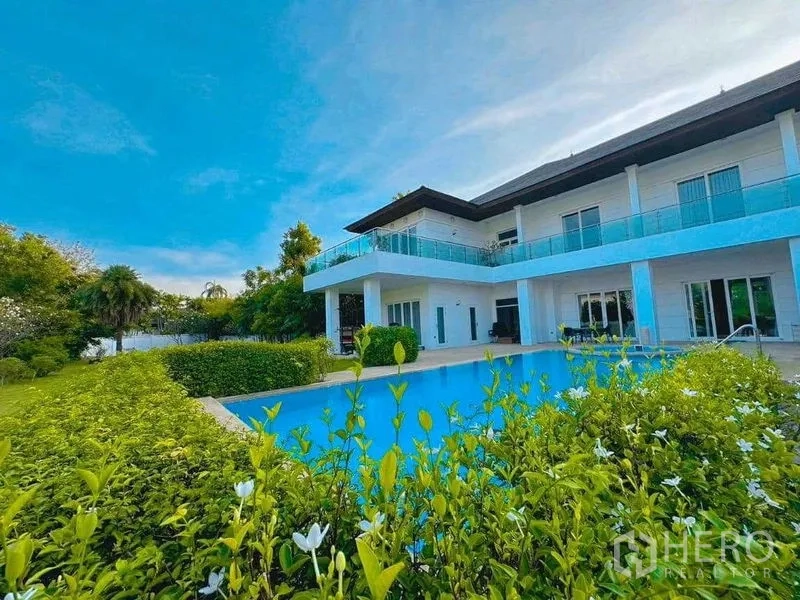 Detached House for rent or sale in Bang Phli, Samut Prakan - Villa exterior with wraparound balcony and pool framed by flowering shrubs
