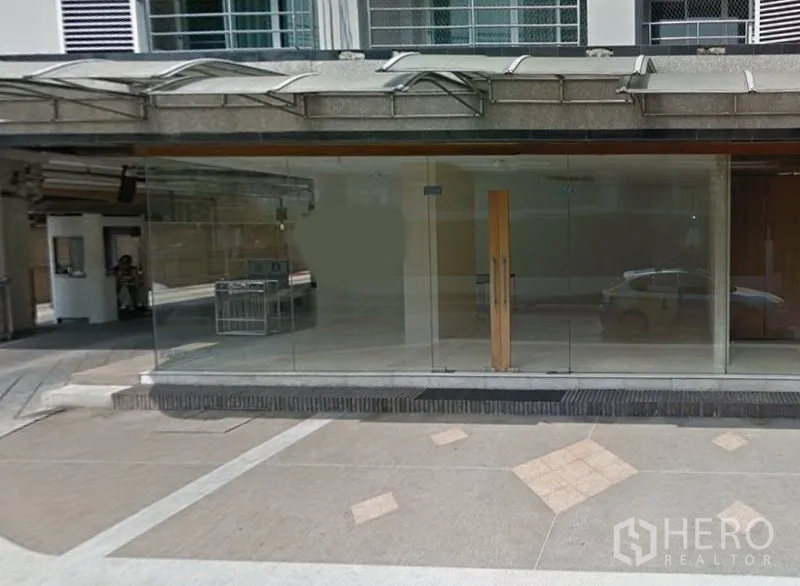 Retail Space for rent in Watthana, Bangkok - Street-level retail unit with full-height glass facade and wooden double door in Watthana, Bangkok