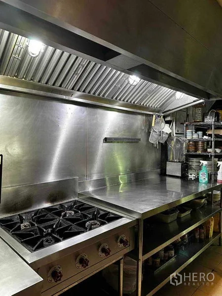 Retail Space for rent in Watthana, Bangkok - Gas cooktop and stainless workbench beneath industrial extraction hood.