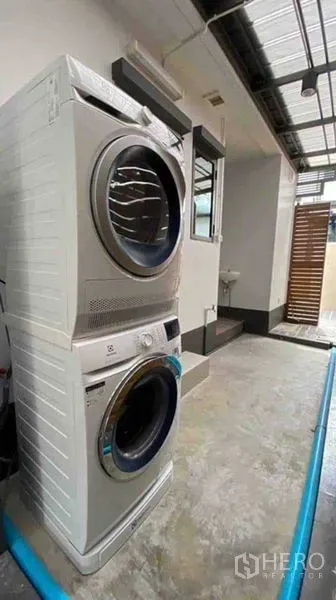 Detached House for rent or sale in Prawet, Bangkok - Stacked washer and dryer in a covered outdoor laundry area.