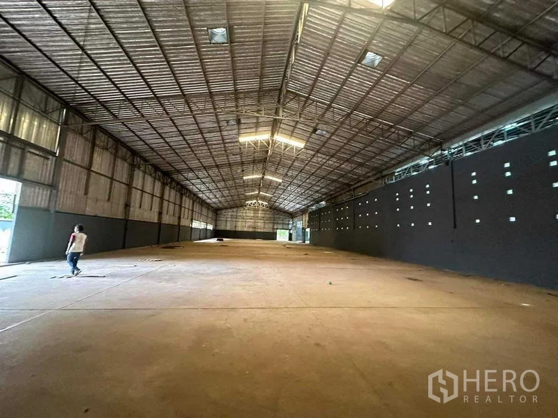 Warehouse for rent in Phra Nakhon Si Ayutthaya - Deep warehouse hall with roof skylights and open loading doors.