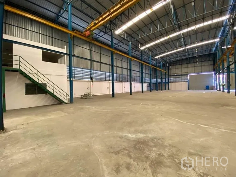 Factory for rent or sale in Bang Sao Thong, Samut Prakan - Factory floor with mezzanine office area, stair access and clear-height ceiling for flexible machinery layout.