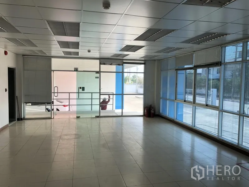 Factory for rent in Bang Sao Thong, Samut Prakan - Ground-floor reception office with glass entrance and full-height windows.
