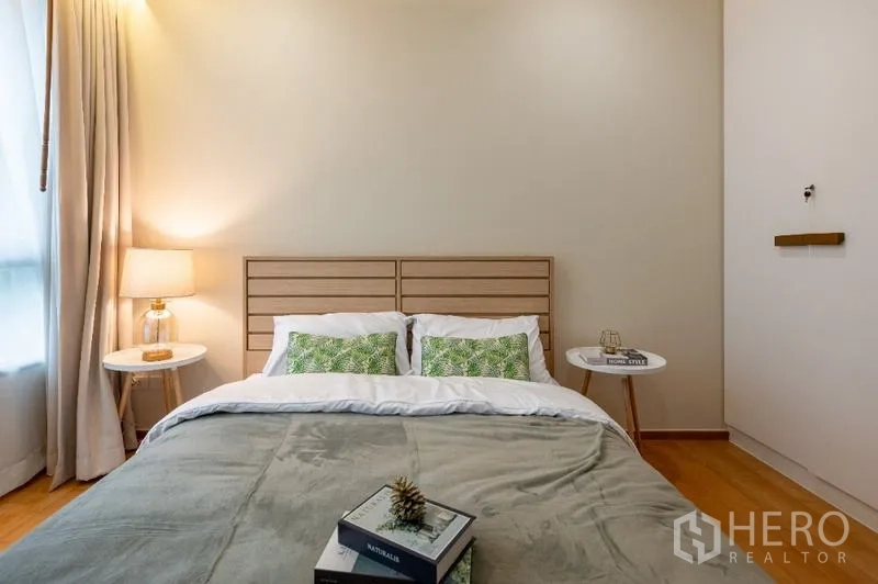 Condominium for sale - Bedroom close-up of bed with twin nightstands and ambient lamp.