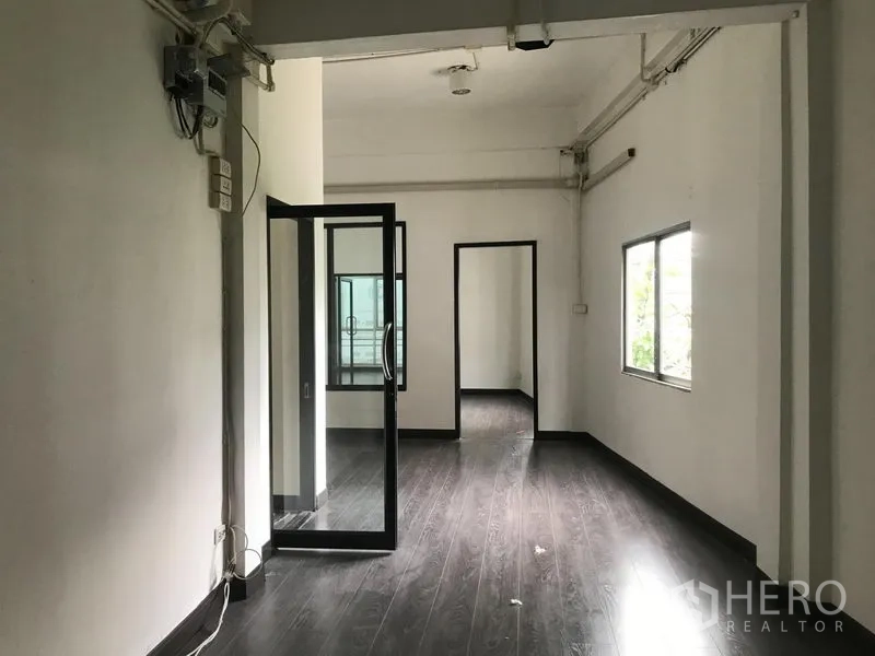 店屋 出租在Watthana, Bangkok - 开放式楼层，深色地板，内置玻璃门与侧窗连接多间房
